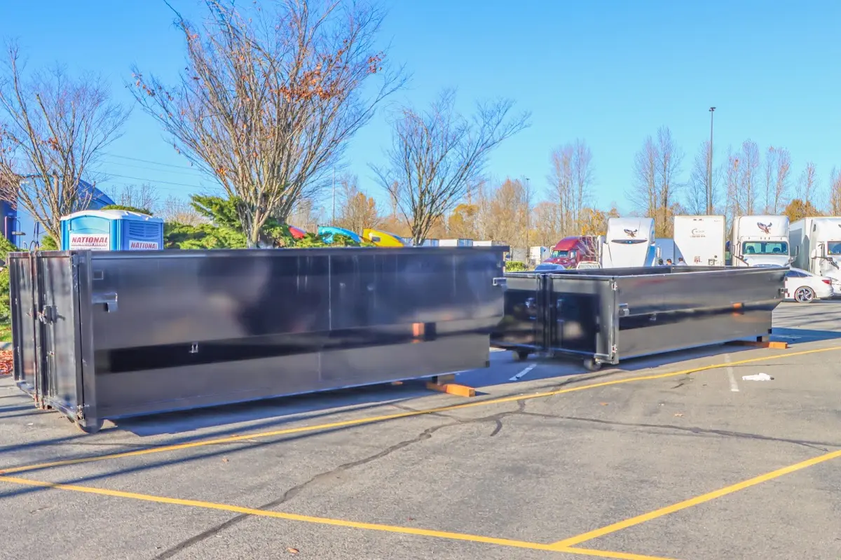 Professional dumpster rental service with roll-off container on residential driveway in Johnston